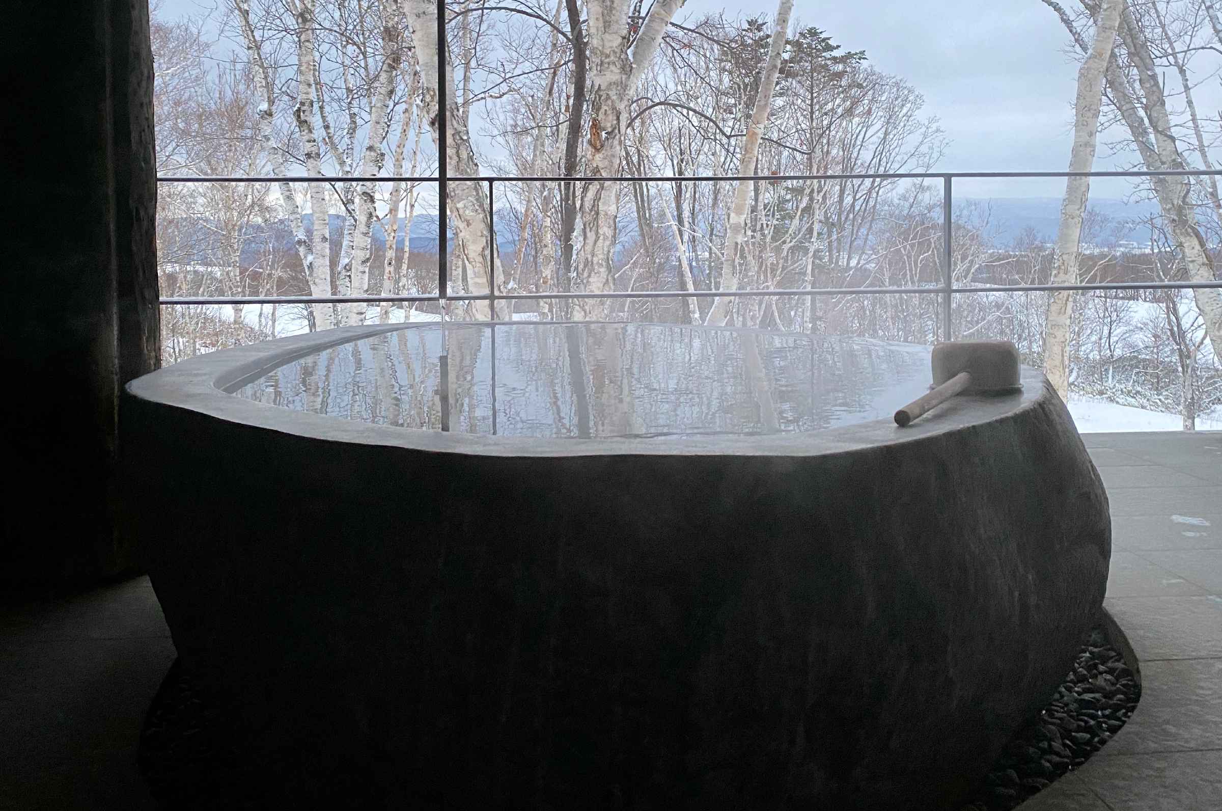 Photo of the outside stone bath full of hot spring water