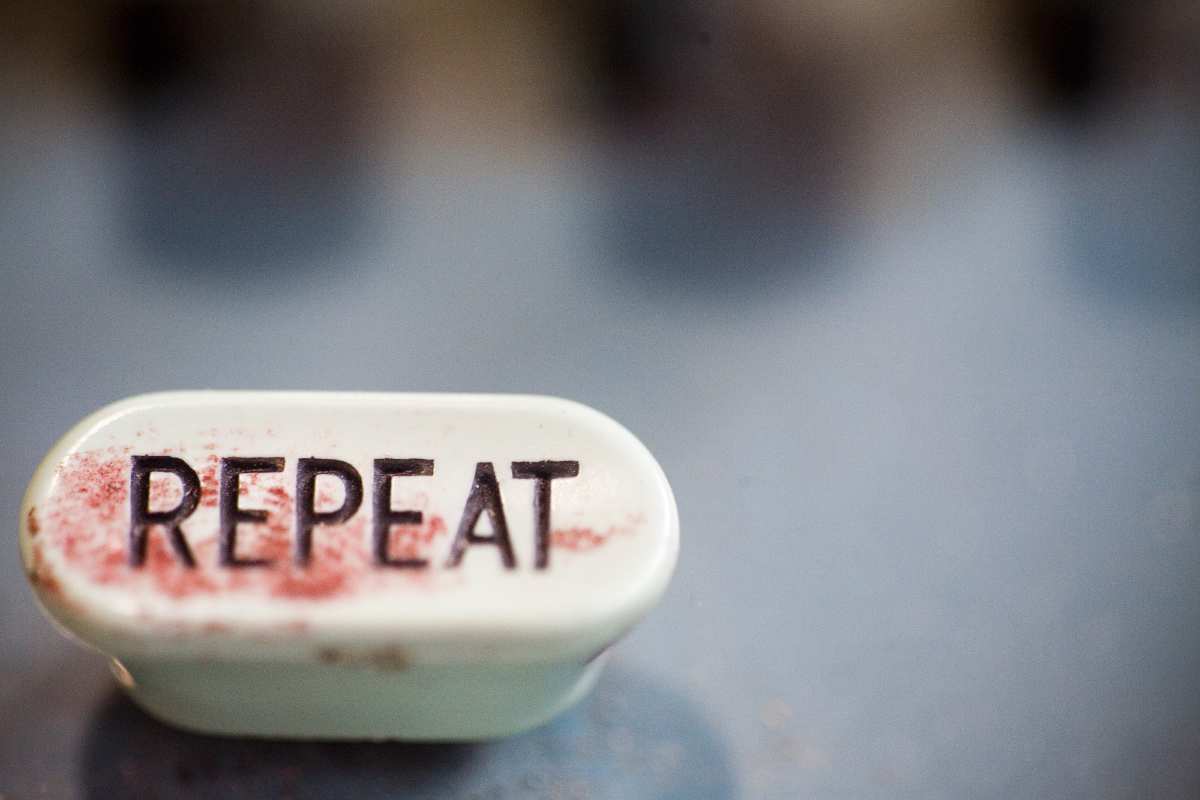 A mechanical button reading 'repeat'