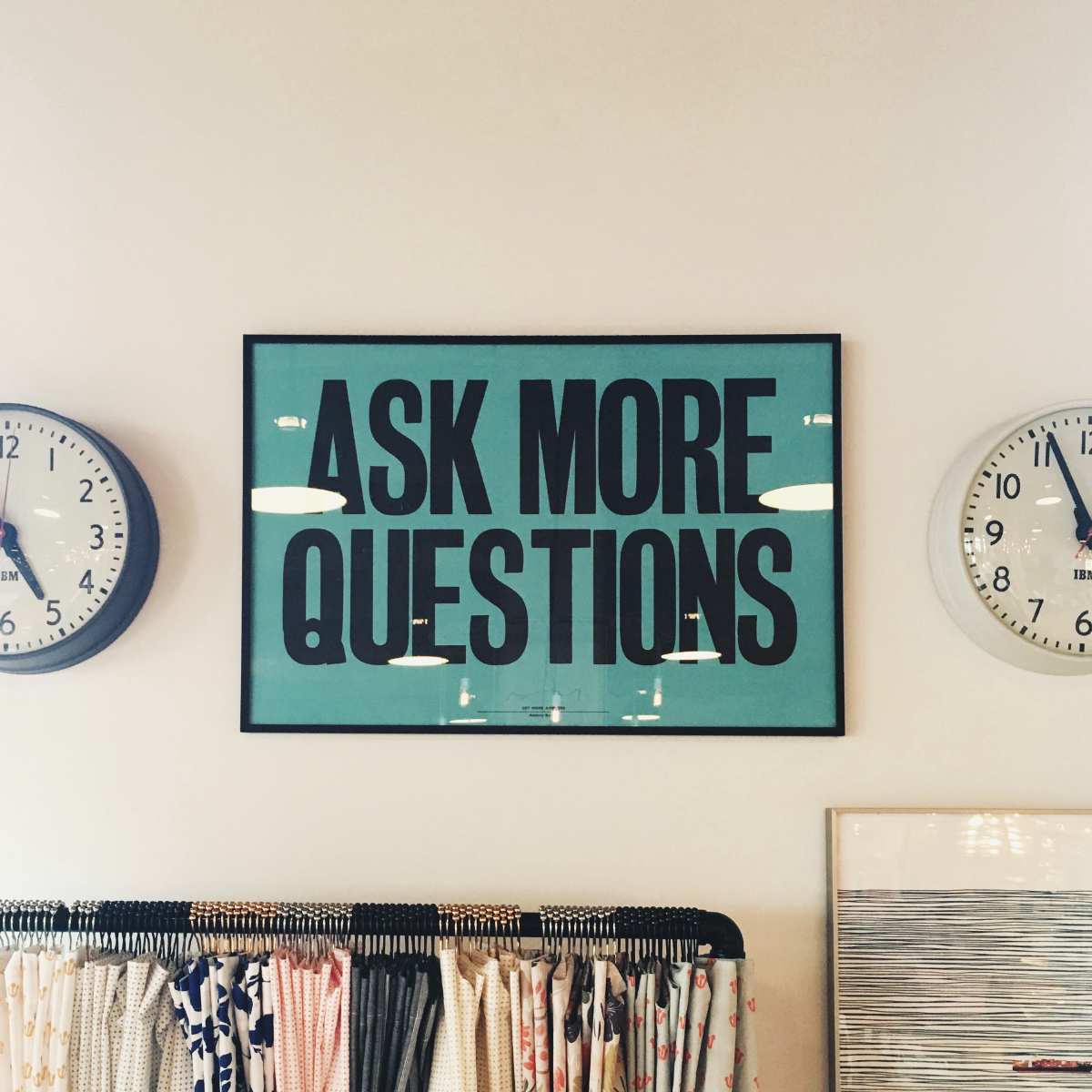 Photo of a poster reading 'Ask more questions'